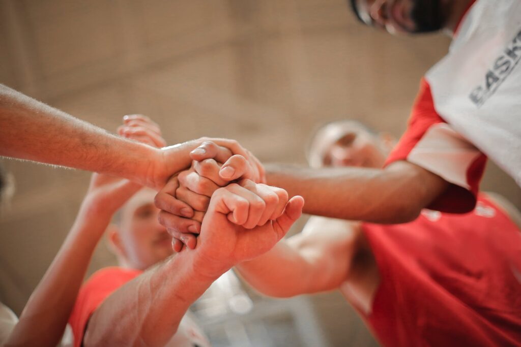 A Rugby team stacking hands together