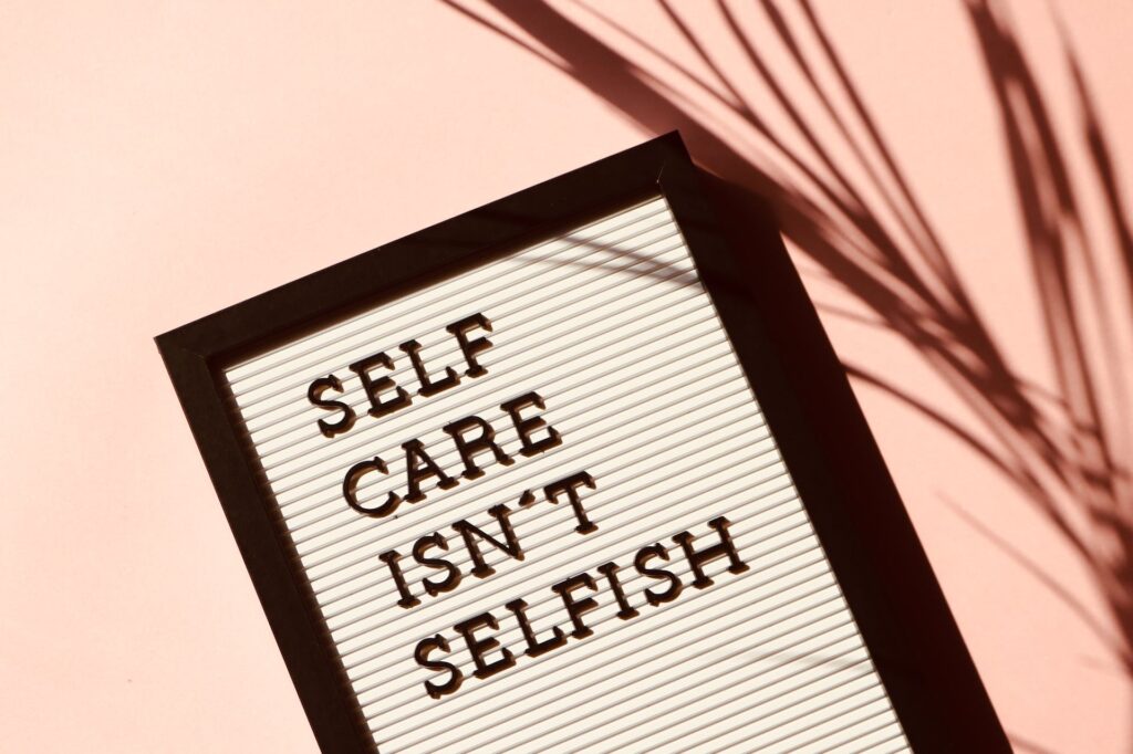 Self Care Isn't Selfish Signage with black frame
