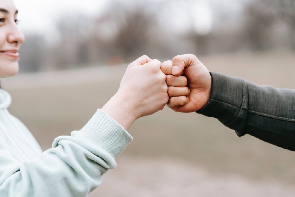 A man and a woman fist bump