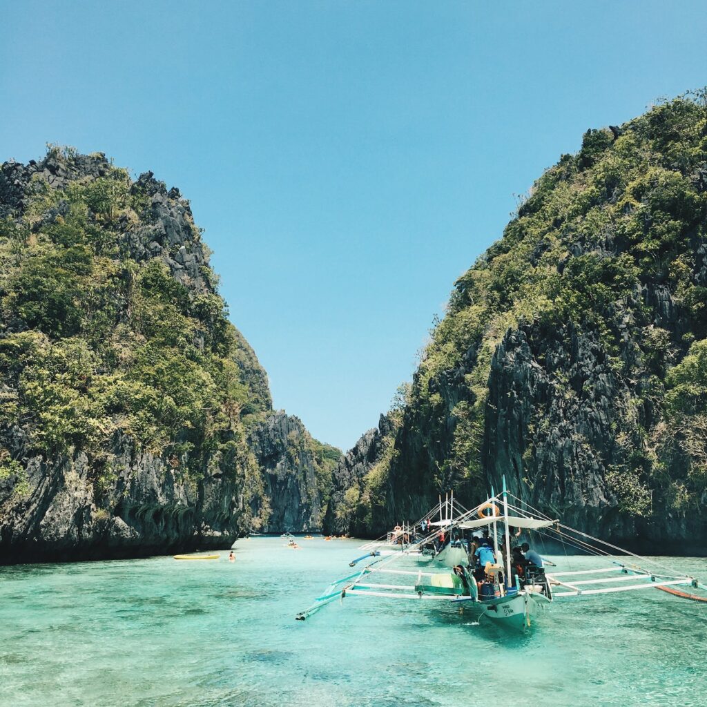 White and green sail boat photography:
one of the best affordable eco-travel destinations in Philippines