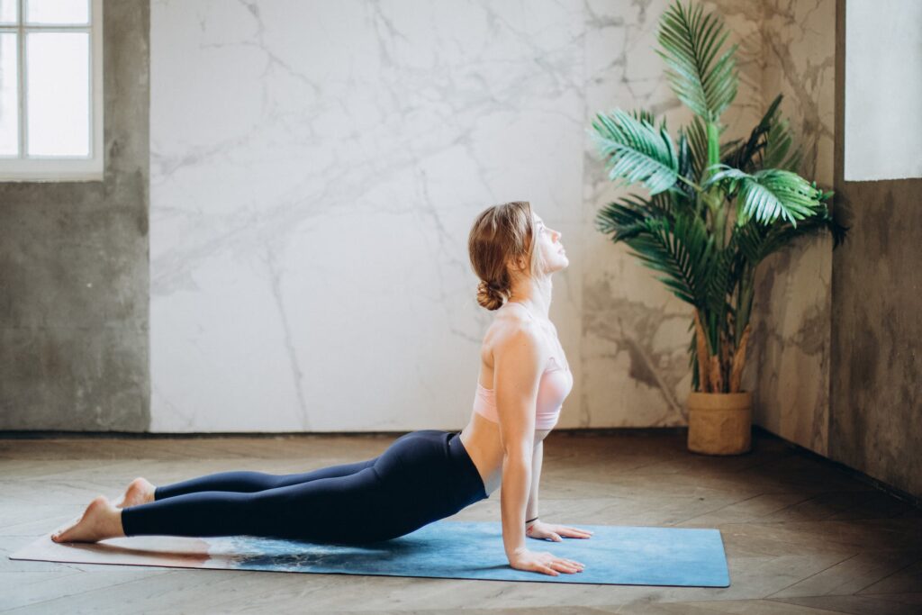 A lady doing yoga: self-care activities at home