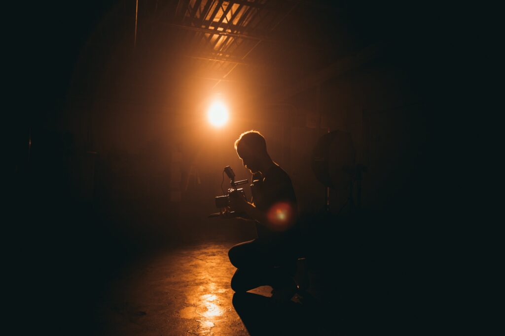 A photographer taking photos in the dark environment