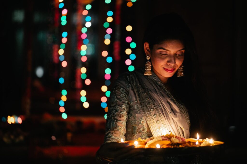 A women with traditional outfit lighting candles