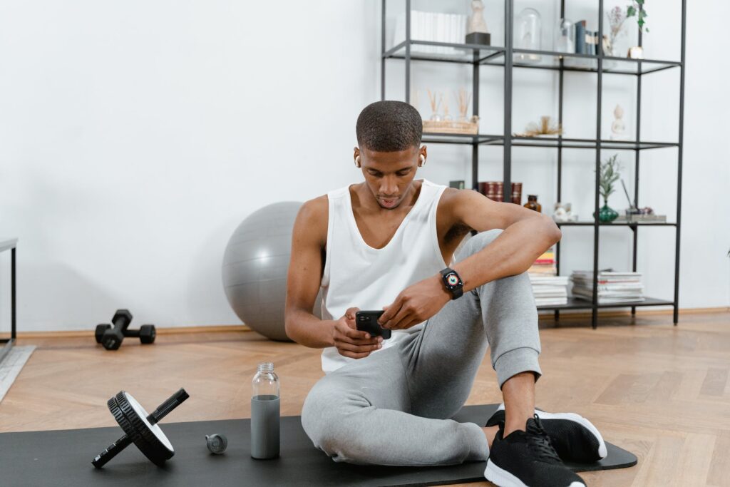 A boy searching home workout routines for beginners through his phone