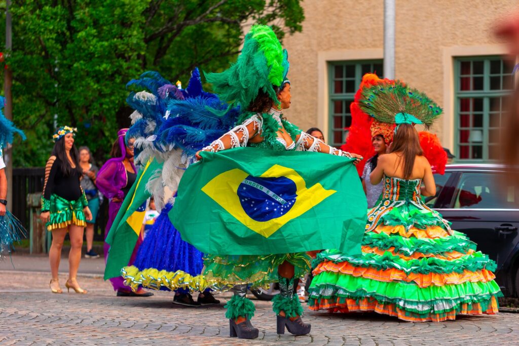 People in Costumes Holding a Brazilian Flag and Celebrating their festival
