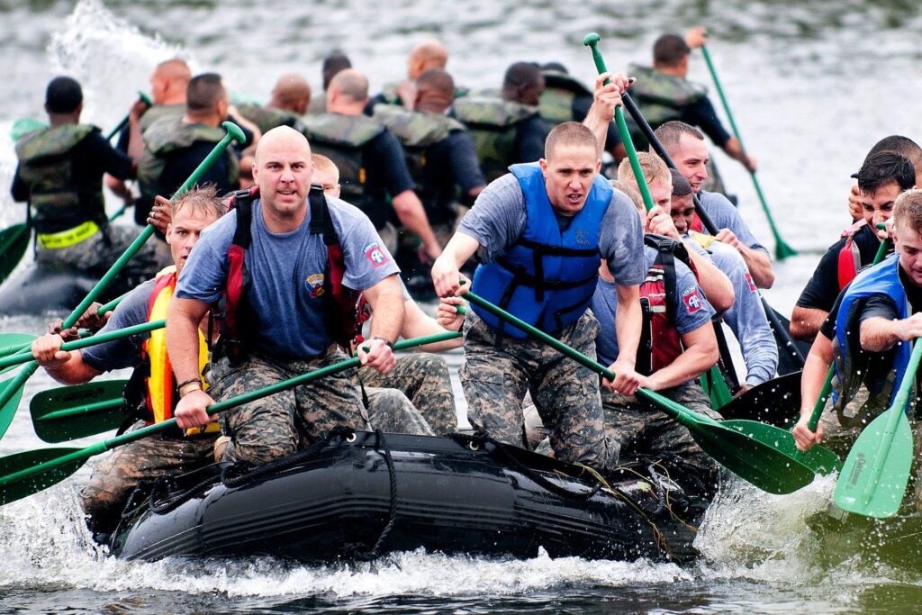 Group of people paddling in raft Boats shows developing soft skills and personality