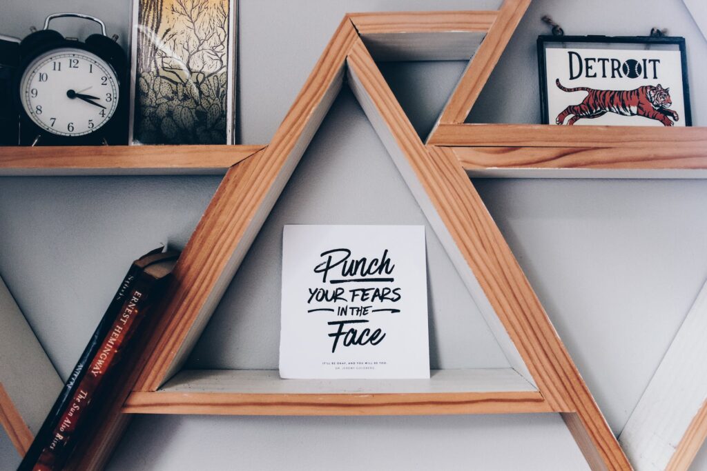A wooden shelves with a inspirational quotes for work printed paper