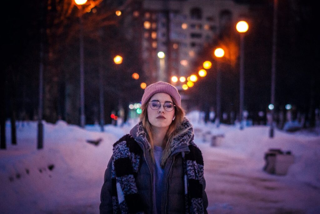 A girl walking on the road at night in the winter season
