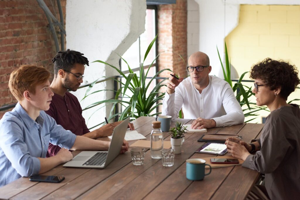 Four people engaging in a meeting