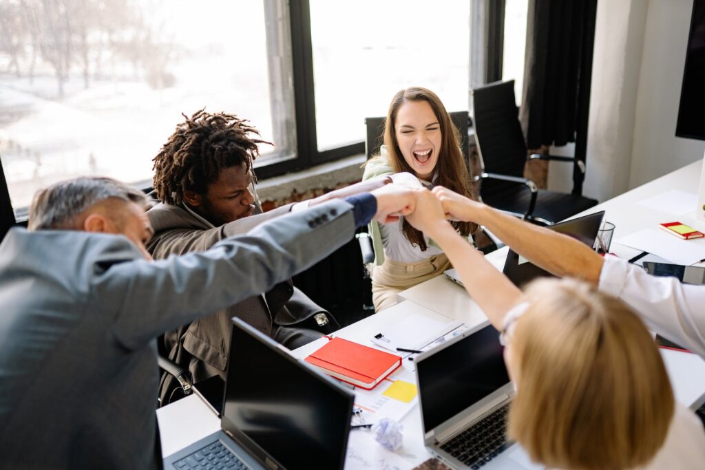 Coworkers fistbumping to get midweek motivation