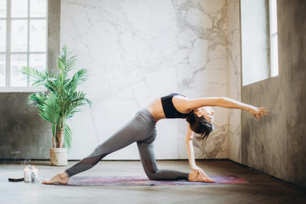 A woman practicing yoga on a yoga mat