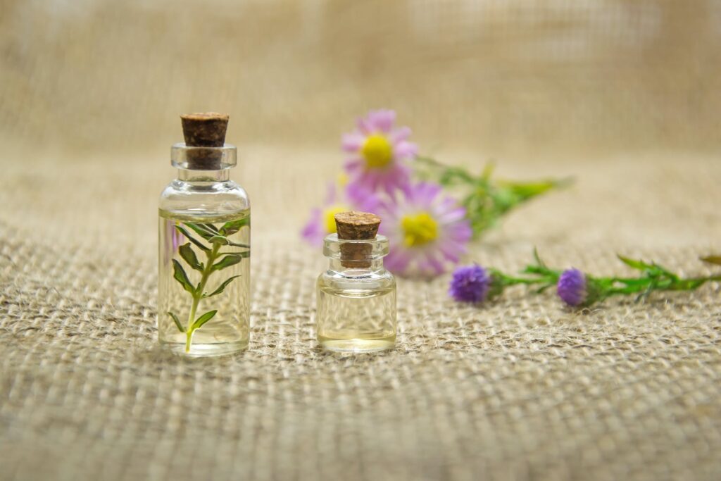 Two clear glass bottle of oil from naturally beautiful plant products