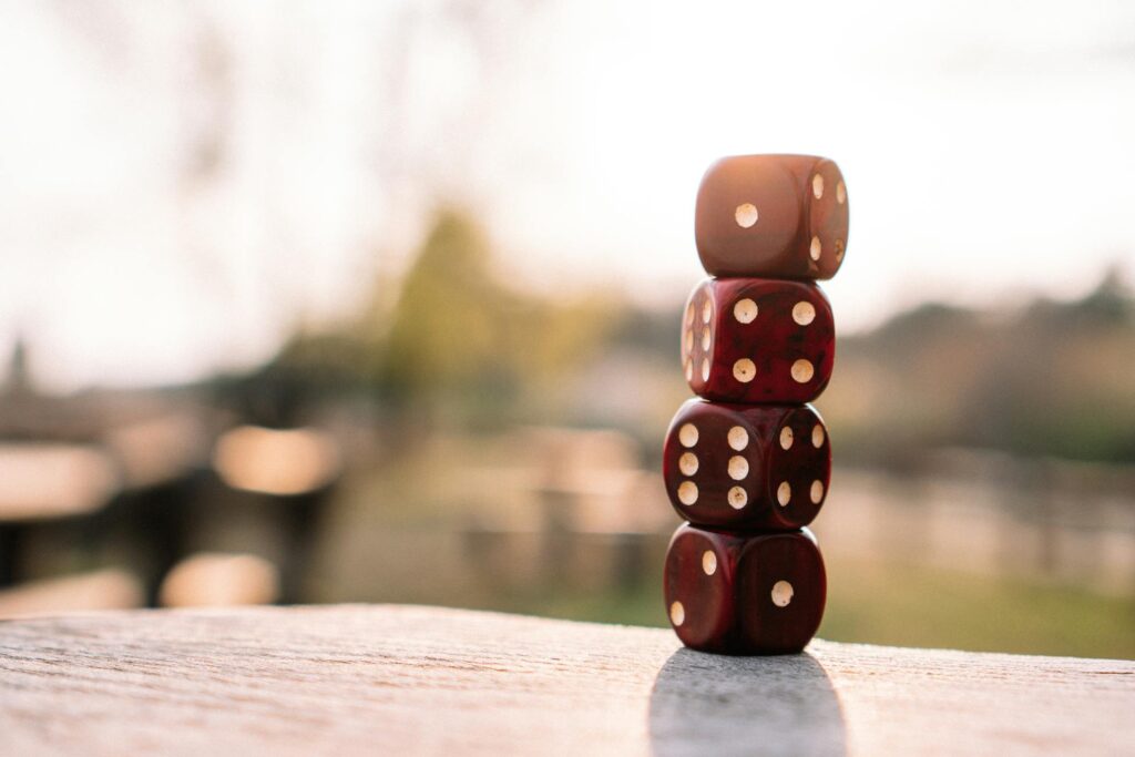 Brown dice stacked on a flat surface