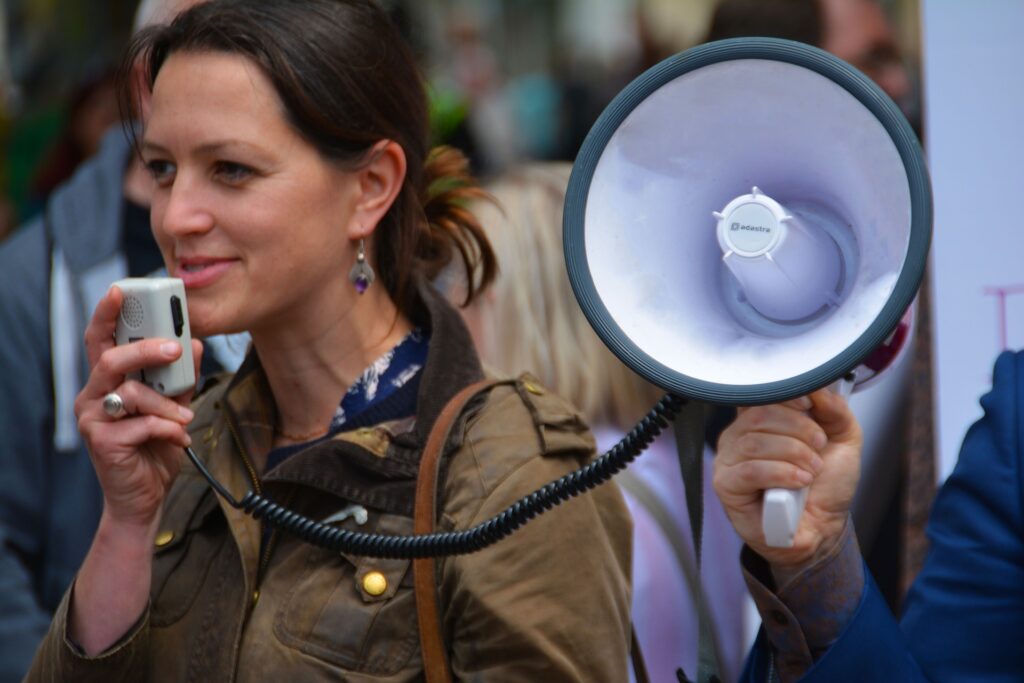 A woman speaking through a megaphone