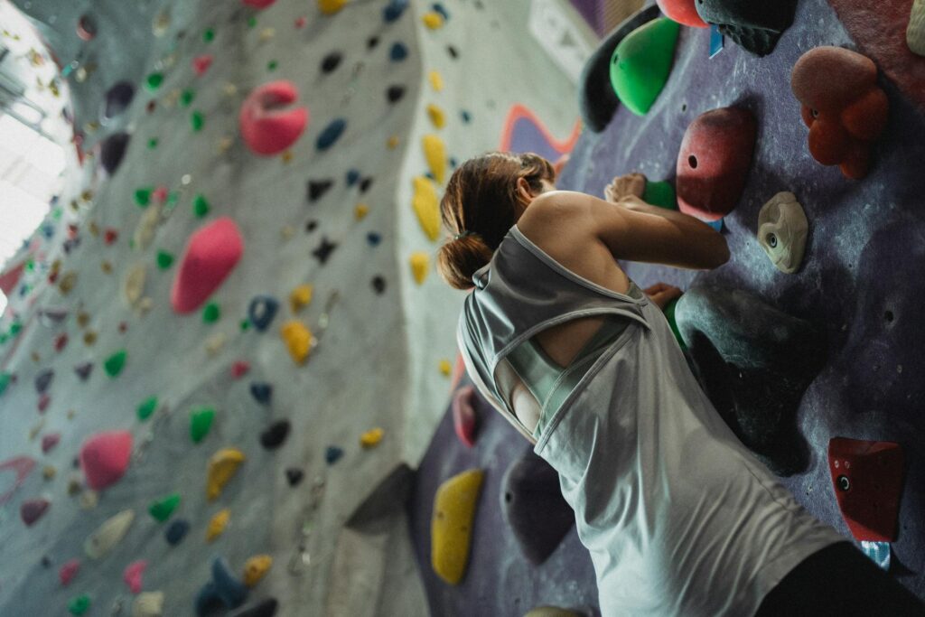 A girl climbing a wall indicating motivational signs