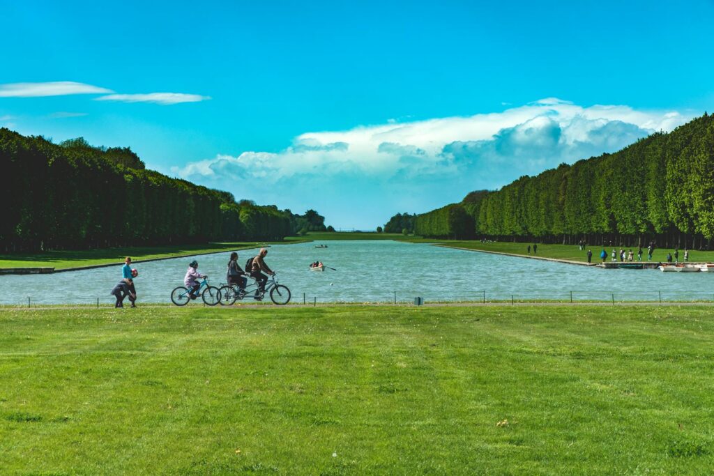 People riding bicycle beside the lake 