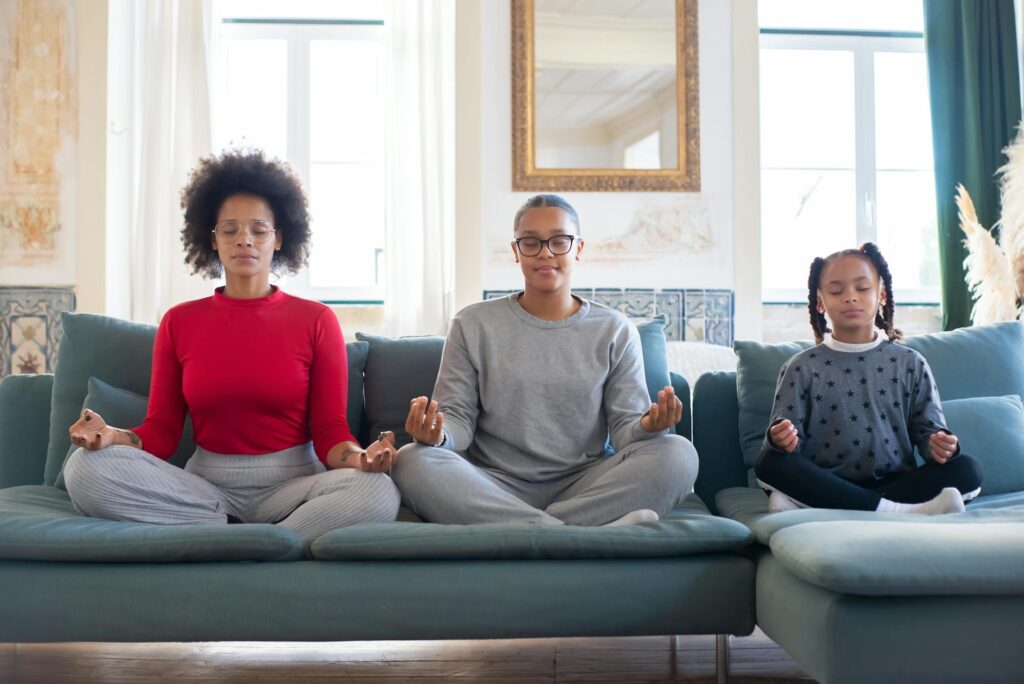 Mom and two children practicing meditation as part of 28-day no yelling parenting challenge