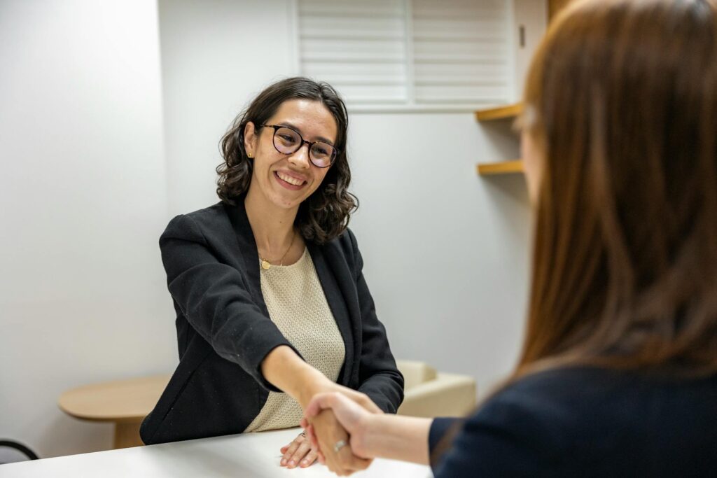 Women shaking hands during an interview
