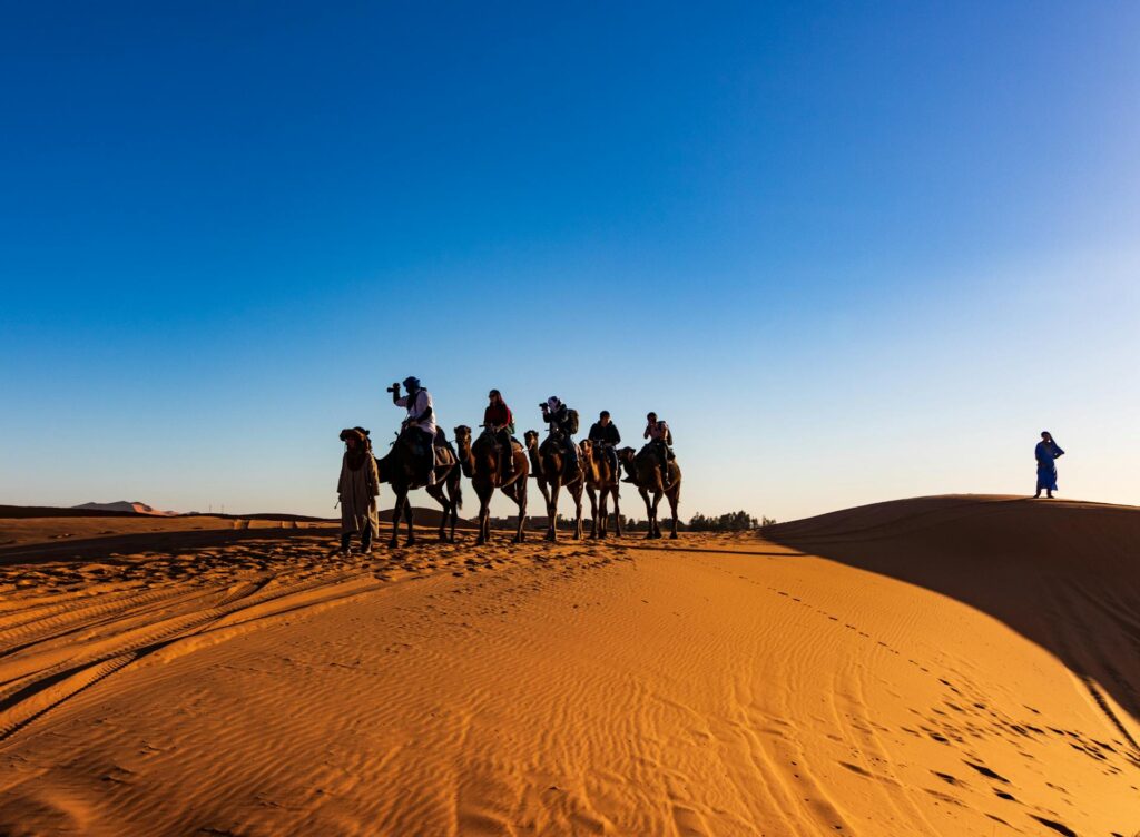 People riding on camel in a desert