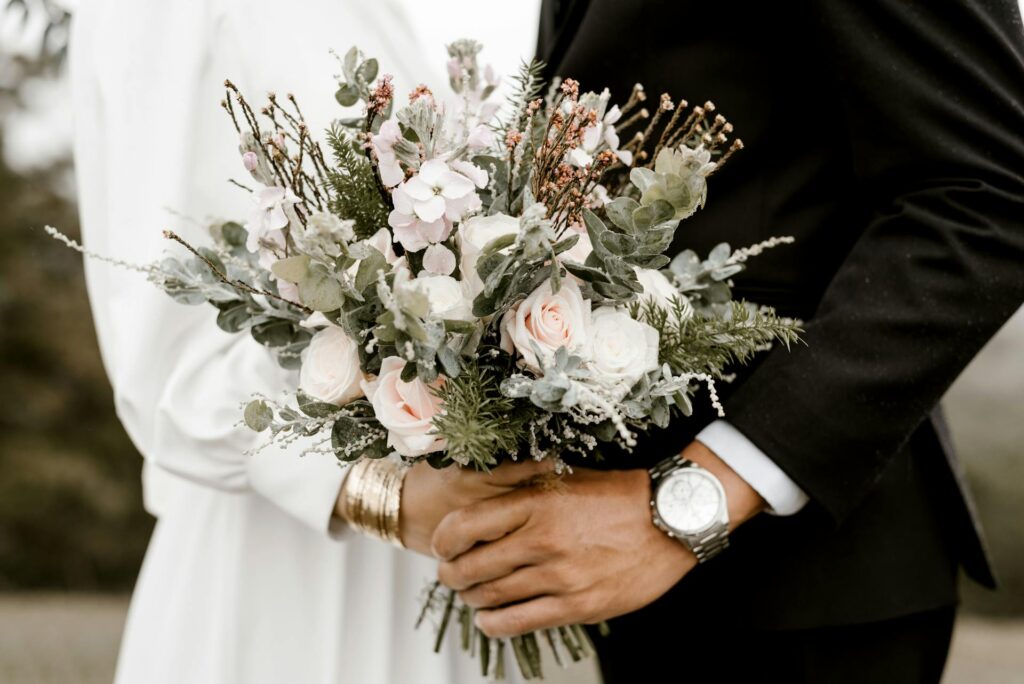 A couple on their weeding day holding the flower bouquet